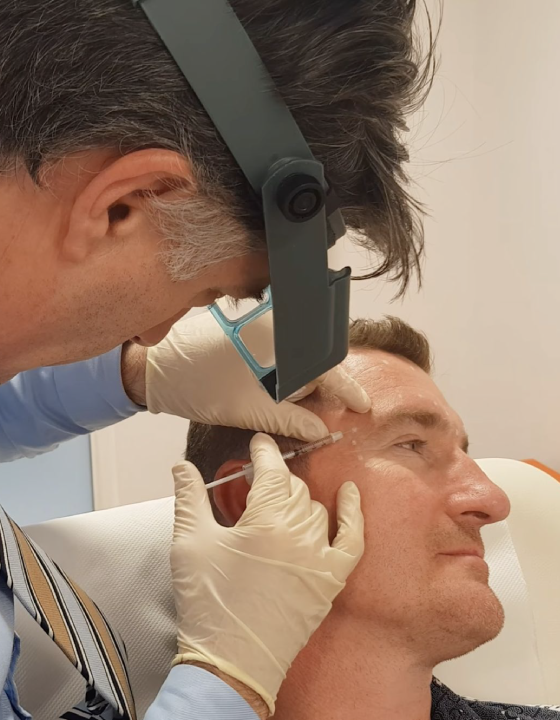 Dr Martin Wade treating a male patient